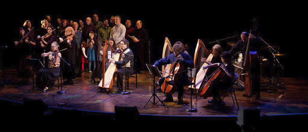 harps singers and string players on a lit stage