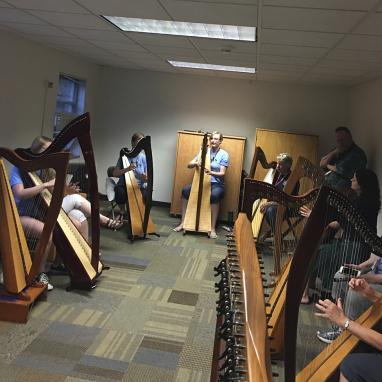 many people with harps in a room at night