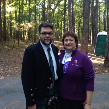 man in kilt stands next to woman